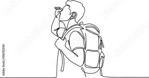 Young man with a backpack drinking.