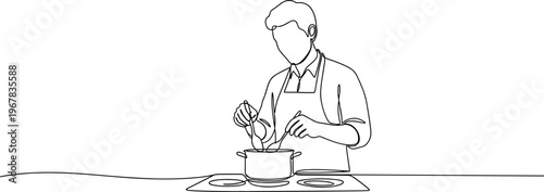 Man wearing apron cooking in kitchen.