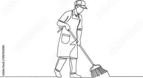 Man wearing apron sweeping floor.