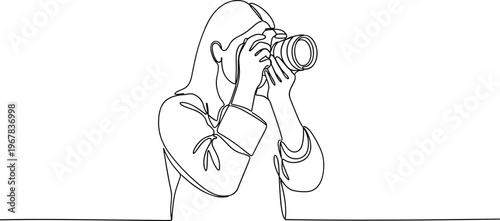 Woman holding a camera to her eye.