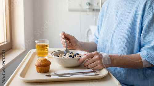 A hospital patient with an IV eats a nutritious recovery meal of oatmeal and blueberries. Focus on health and wellness