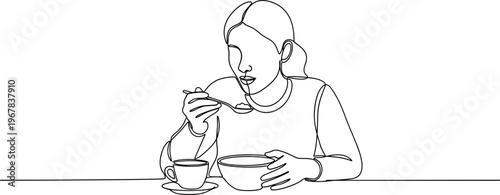 Woman eating breakfast with spoon.