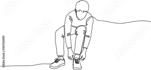 Man tying his shoelaces on ground.