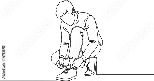 Man tying his shoelaces on ground.