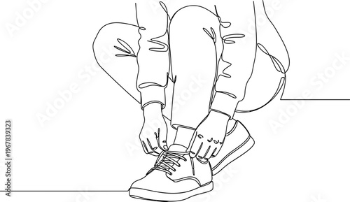 Person tying athletic shoe laces.