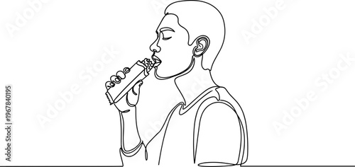 Young man drinking from bottle.