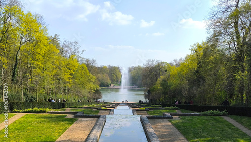 Tablou pe pânză Formal Garden with Reflecting Pools Leading to Fountain and Lake in Parc de Scea