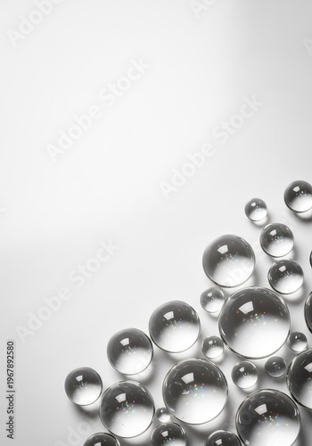 Transparent liquid beads rest on a clean white backdrop, capturing light and reflecting a sense of freshness and natural hydration today, white, nature, aqua