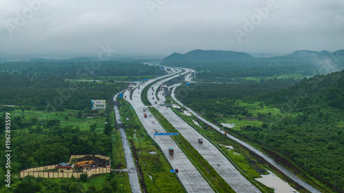 Tableau sur toile A breathtaking aerial view of the Samruddhi Mahamarg in Maharashtra, India, gracefully curving through vibrant green fields and rolling hills during the monsoon season