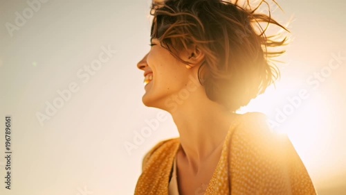 Woman smiling in the sunlight outdoors.