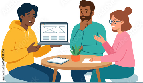 People discussing on laptop at table with notebook and plant