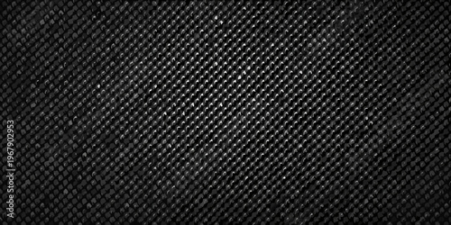 Close up of a dark textured fabric with a repeating diamond pattern