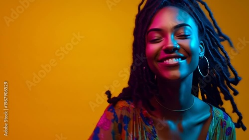 Woman with dreadlocks smiling freely.