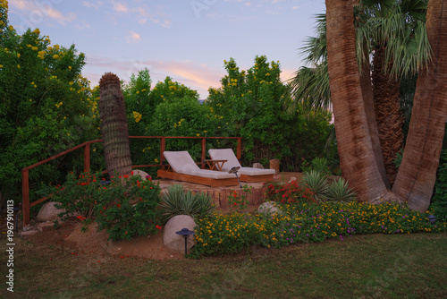 Recliner chairs nestled in a tranquil garden with greenery all around in California.