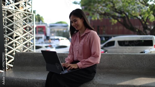 Young businesswoman working remotely on laptop outdoors, enjoying freedom, travel lifestyle, mountain views, productivity, and successful modern career in nature.
