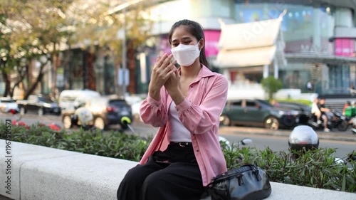 Person wearing mask in toxic urban air, monitoring pollution levels on device, highlighting health risks, environmental hazards, smog, and city pollution concerns.

