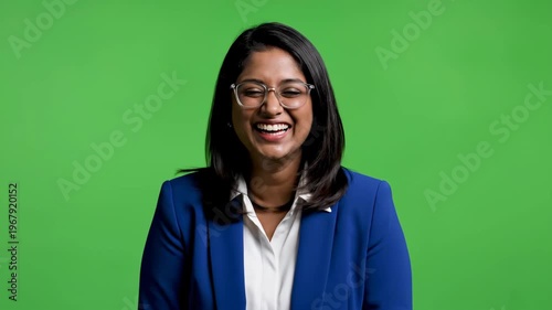 Confident professional woman smiling in front of green screen