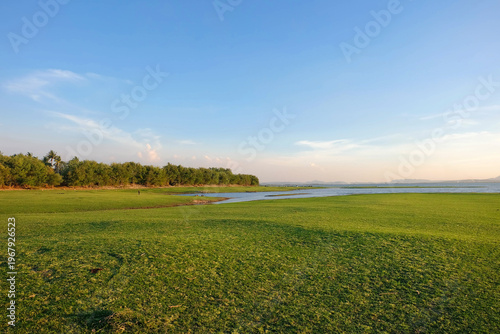 A beautiful view of grasslands and a river.