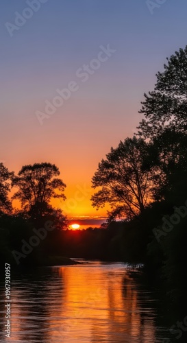 A serene lake scene at sunset with trees and a vibrant sky