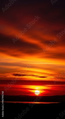 A sunset over the ocean with clouds in the sky