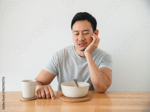 Photos Silent workday lunch scene with tired expression and untouched meal