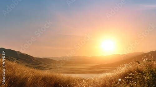 A golden sunrise illuminates a serene, grassy valley surrounded by rolling hills and distant mountains under a clear sky.