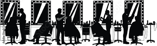 Black and white silhouettes of professional hair stylists and makeup artists working with clients in a beauty salon with lighted vanity mirrors.