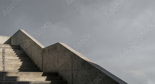 A stark, minimalist shot captures a concrete staircase against a cloudy sky. 