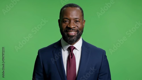 Confident professional businessman in suit on green screen background