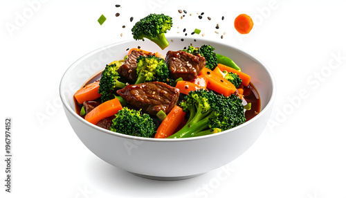 Delicious beef and broccoli stir fry with carrots and sesame seeds in a white bowl on white backdrop; a fresh and vibrant dish presented.