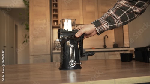 The hand places the multislayer, which is attached to the table with a suction cup