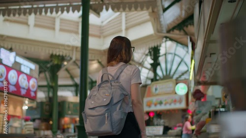 Woman looking at cafe window at Lau Pa Sat hawker center in Singapore, famous street food market and travel destination in Asia