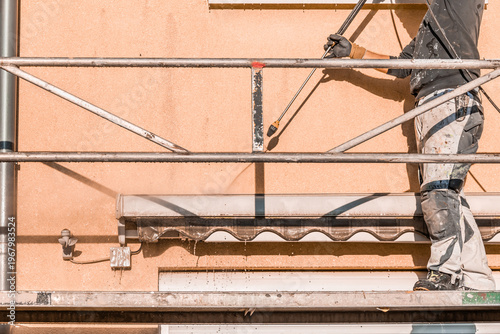 Power washing dirty house siding, a high pressure water jet cleaning