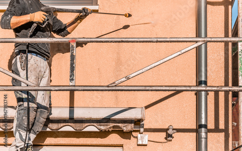Power washing dirty house siding, a high pressure water jet cleaning
