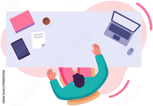 Overhead view of a person sitting at a desk with a laptop and books