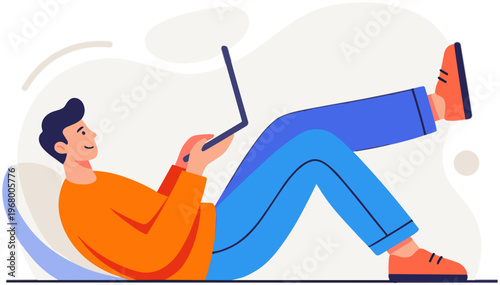 A man lies on floor with laptop on his lap in casual outfit