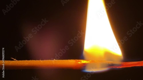 Wallpaper Mural A single wooden matchstick bursts into a bright, flickering flame. The glowing orange fire consumes the wood, creating a sense of warmth and fleeting power. It is a simple yet captivating sight. Torontodigital.ca