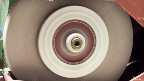 Wallpaper Mural A motorized abrasive wheel rotates at high speed against its housing. The rapid motion generates a consistent, mechanical whirring sound and a low-frequency hum. Torontodigital.ca