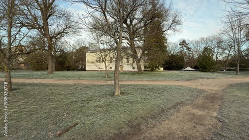 Wallpaper Mural The historic yellow mansion stands quietly behind a field of silver frost. Bare winter trees and a winding dirt path create a nostalgic, peaceful feeling in the cold morning air. Torontodigital.ca