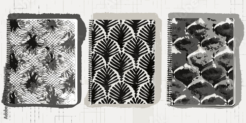 Three patterned spiral notebooks displayed against a light wood background