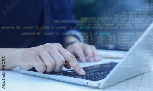 close up computer programmer man hand typing configuration on keyboard at laptop for input coding language to software for fix bug and defect of system in data center room , engineering and technology