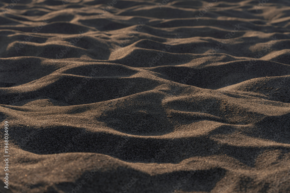 Fototapeta premium Natural abstract texture background with minimal composition and flowing organic patterns. Close up of wind formed sand ripples.