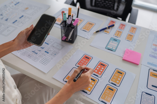 Fototapeta Designer creating mobile application user interface wireframes