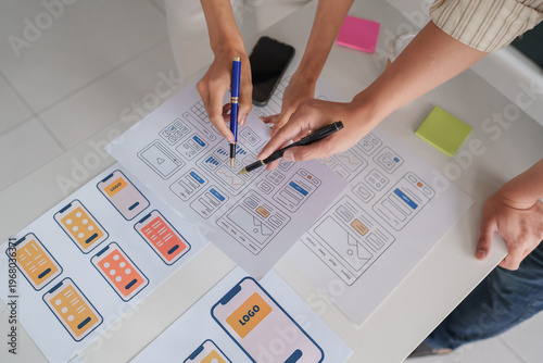 Tableau sur toile Designers collaborating on mobile application ui ux wireframes