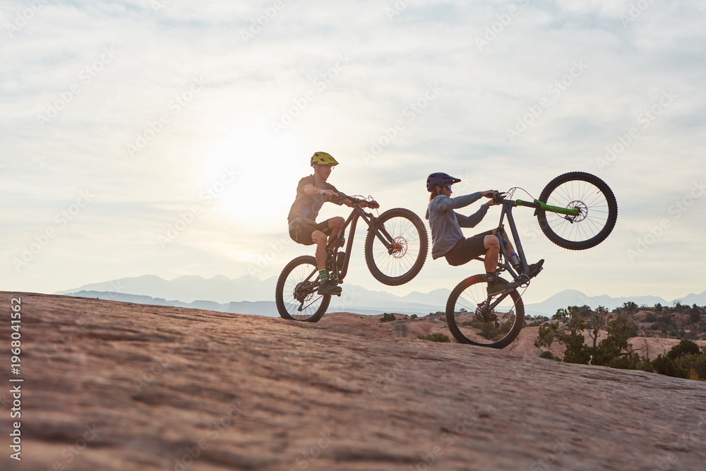Fototapeta premium Mountain bike, men and journey for fitness, travel and extreme sports with hobby. Trick, healthy people and friends with training, cyclist and adventure to explore, adrenaline and power performance