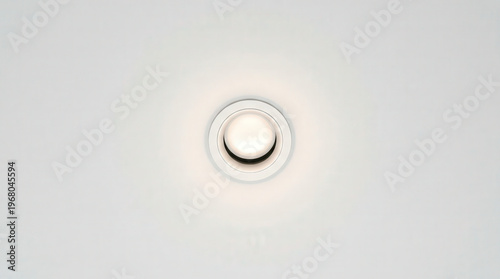 Close-up of Designer Circular Smoke Detector on White Ceiling for Safety and Security