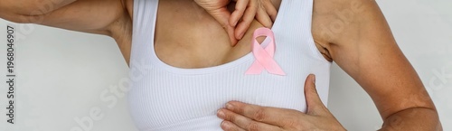 Canvas Print Woman with pink ribbon on her chest to promote breast cancer awareness