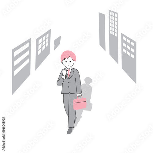 スマートフォンを見ながら道を歩くビジネスマンの男性