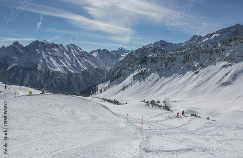 European Alps at skiing area Brandnertal, snowy mountains with blue sky