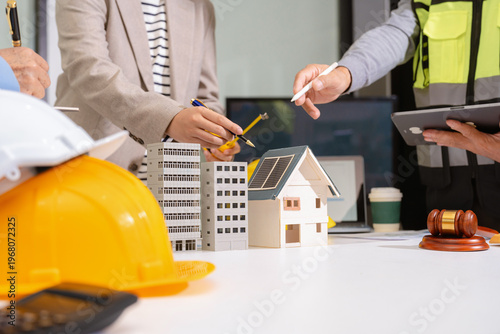 Fotografie Concept of construction law, real estate development, renewable energy housing, and engineering collaboration